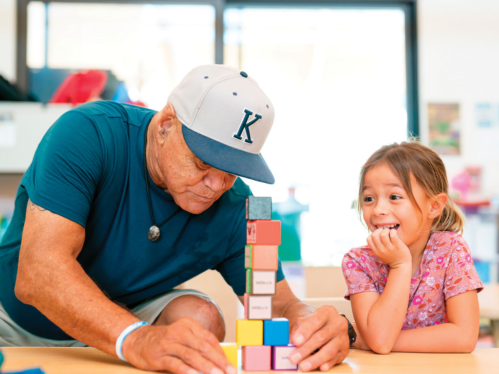 grandpa playing with blocks with his granddaughter