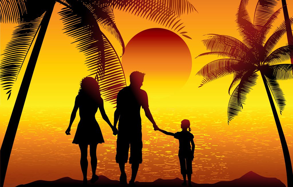 silhouette of a family walking on the beach at sunset